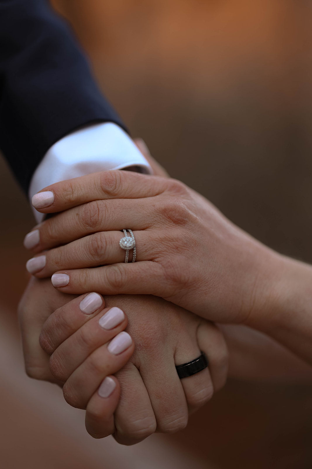 A close-up of the couple’s hands and wedding rings, symbolizing the commitment made during their elopement in Colorado.