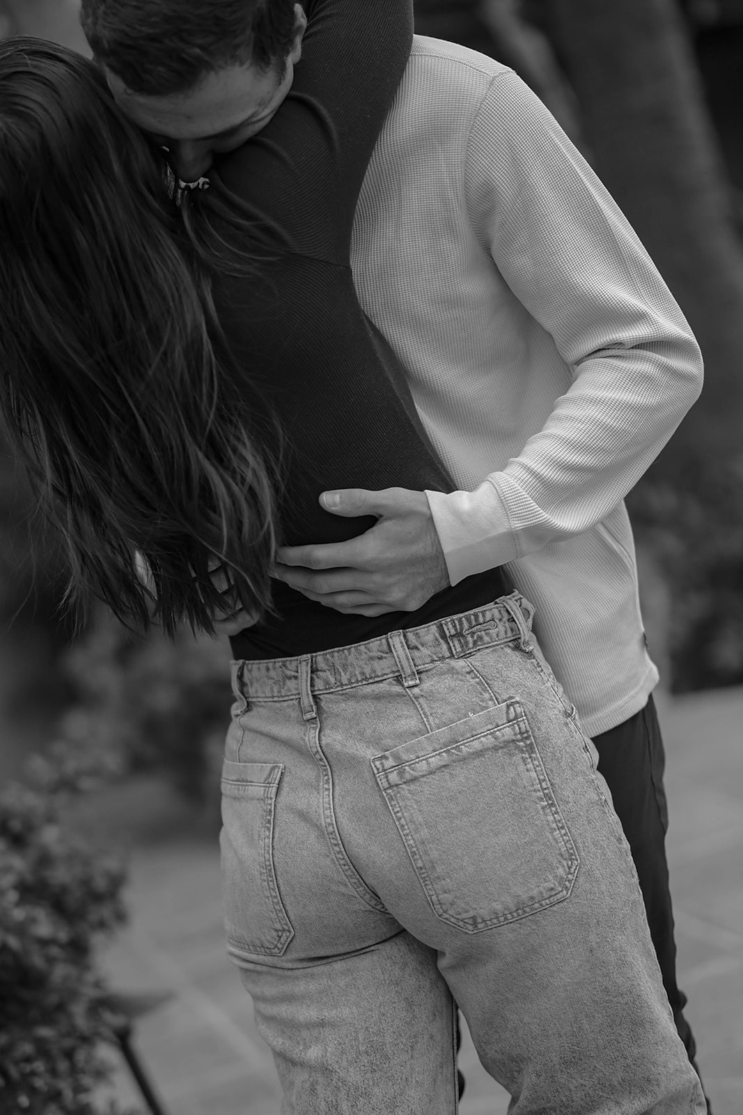 Black-and-white couples photos of an intimate kiss and embrace.