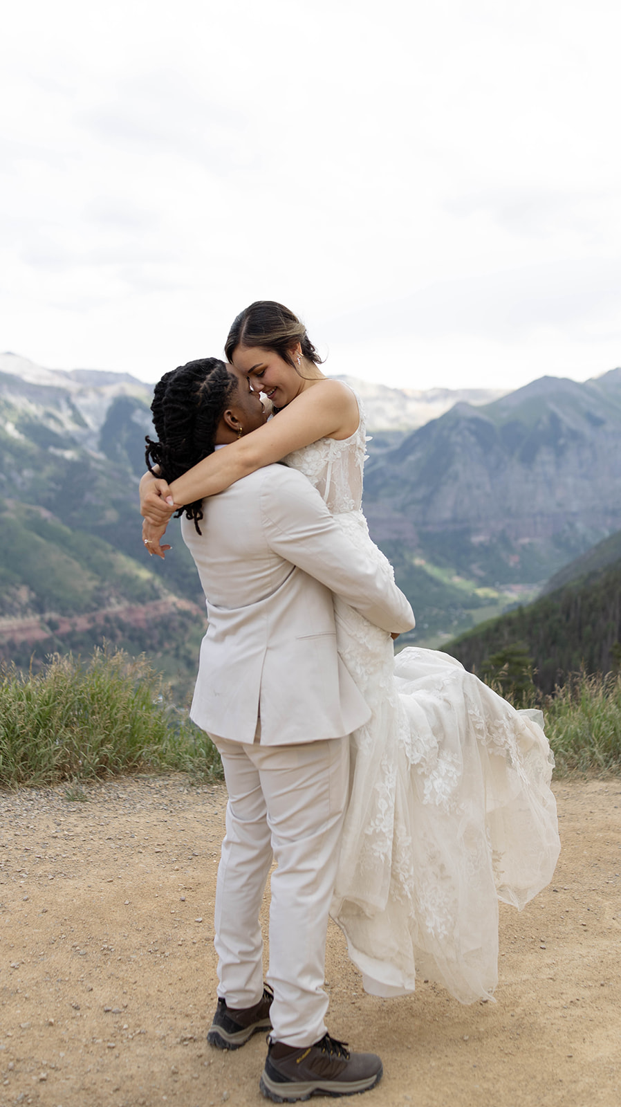 Close-up of bride and groom’s hands showing their wedding rings.