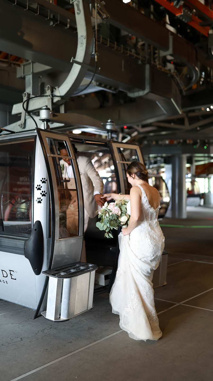 Bride steps into a gondola, bouquet in hand, as the groom helps her inside—creative elopement ideas for mountain towns.