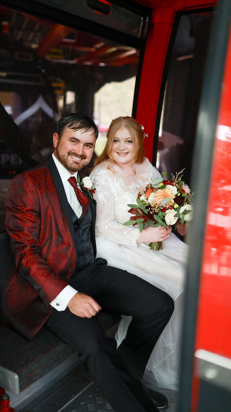 Bride and groom seated together inside a gondola, smiling with bouquet in hand as part of their intimate aspen elopement experience.