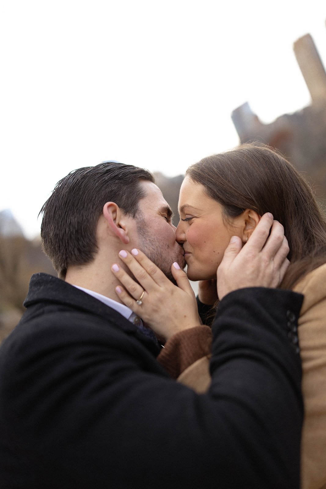 Close-up of a couple sharing a kiss during a Central Park engagement, highlighting intimate emotion and soft natural light.
