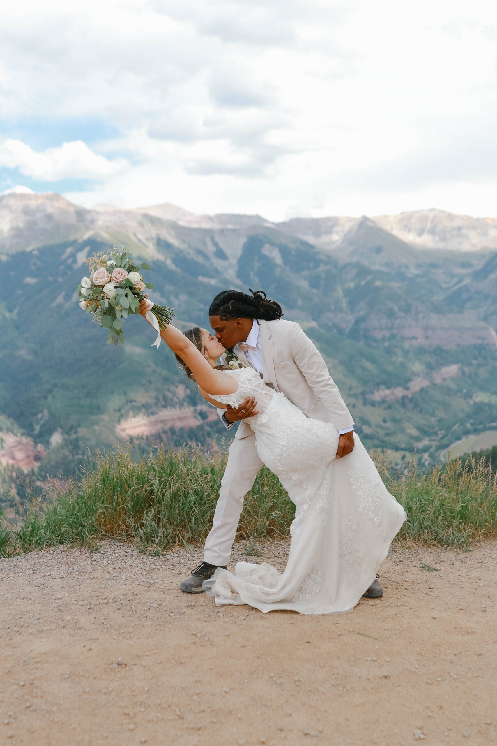 A dramatic kiss as the groom dips the bride, framed by sweeping mountain views during their telluride elopement.